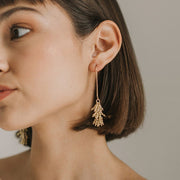 Jaya Beaded Gold Tassel Drop Earrings on model