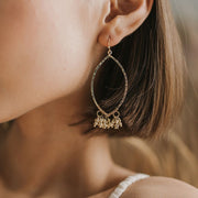 Jaya Beaded Gold Tassel Oval Hoop Earrings on model
