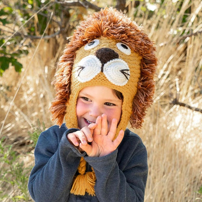 Child wearing a Hand-knit lion-themed winter hat outdoors