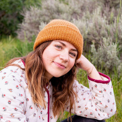 Reversible Milkshake Hand-knit Beanie in Pumpkin Spice color on a female model