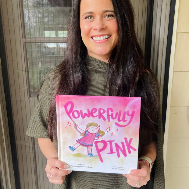 Author Audrey Nixon a copy of her Powerfully Pink Hardcover Book