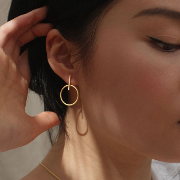 Rover & Kin Luxe Brass Outline Earrings on model