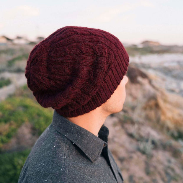Reversible Hand-knit Cable Hat - Berry on model seen from behind