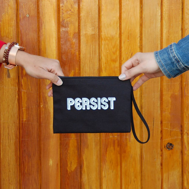 Black Screen Printed Cotton Wristlet Pouch - Persist held by two hands