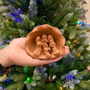 Small Terracotta Shell Nativity held by hand to see proportion