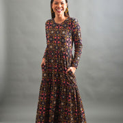 Model wearing the Mata Traders Mirah Long Sleeve Tiered Maxi Dress - Mauve Tile and showing pockets
