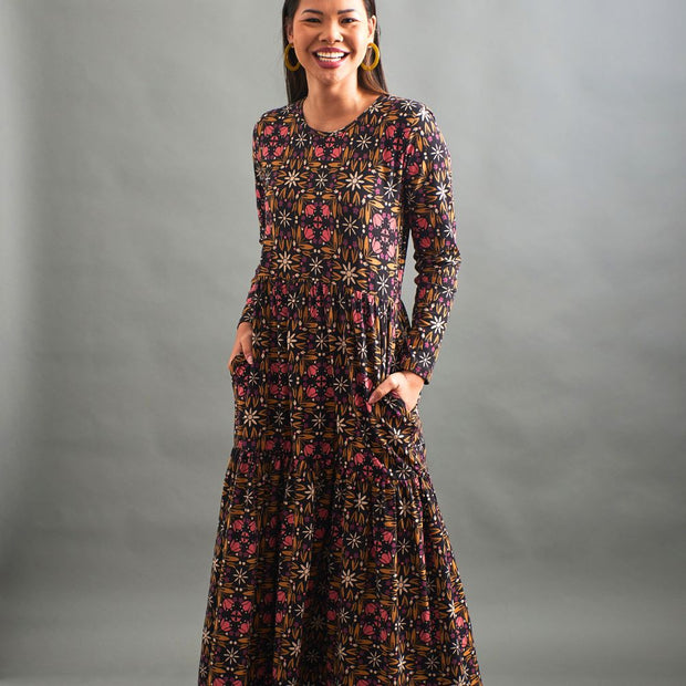 Model wearing the Mata Traders Mirah Long Sleeve Tiered Maxi Dress - Mauve Tile and showing pockets