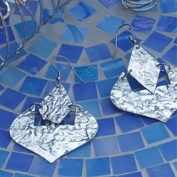 Moroccan Dreams Silver tone Earrings styled against blue tile