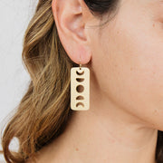 Satellite Dangle Earrings on light skin model