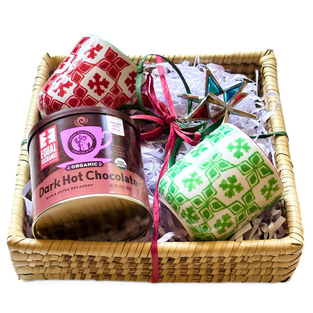 Basket with dark hot chocolate, two mugs, and a colorful star ornament