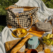 Carryon Weekender Bag in Ink Gingham print styled over a picnic blanket