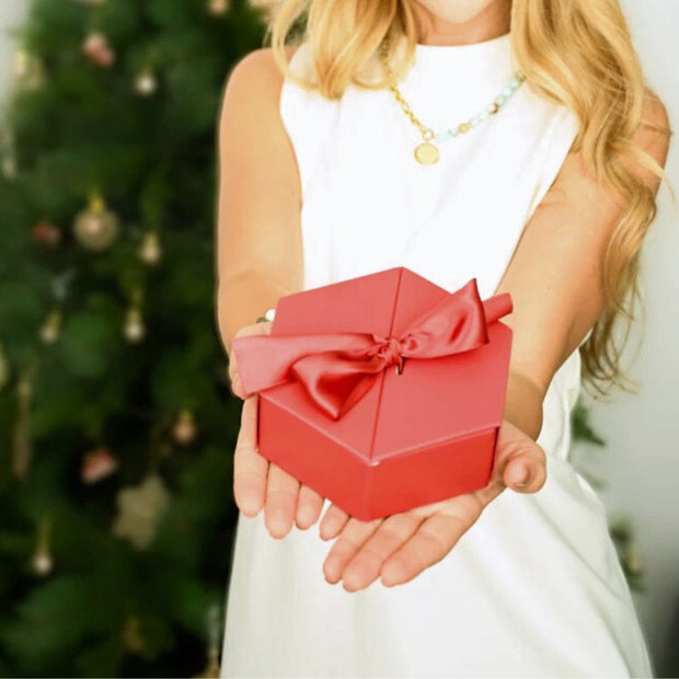 Model holding a Starfish Project Red Gift Box