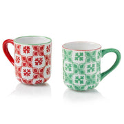 Two ceramic mugs with hand-painted snow star patterns in red and green perfect for hot chocolate