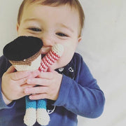 Baby holding a Pebble Child Crocheted Pirate Rattle Toy