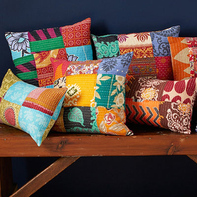 Square Kantha Patchwork Throw Pillow styled with others on a bench