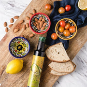 Bottle of Organic Olive Oil next to ceramic dipping bowls