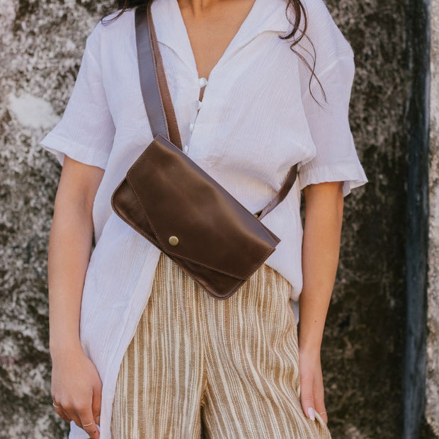 Belt Bag in Brown Leather on model carrying it across front body