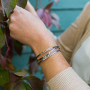 Trust Your Journey Cuff - Silver on model wearing other bracelets