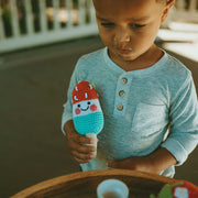 Pebble Friendly Ice Lolly Rattle - Red with White and Blue with little boy