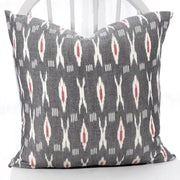 Ikat Fabric XO XO Grey and Red Throw Pillow on a chair