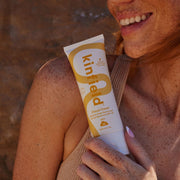 Kinfield Water-Resistant Body Sunscreen SPF 35 model holding one