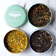 JusTea Loose Leaf Assorted Tea Trio Gift Tin open showing loose tea