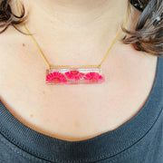 Resin Bar Pendant Necklace with Fuchsia Daisies on model
