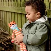 Little Boy playing with a Hand-knit Pebble Fox Rattle Toy
