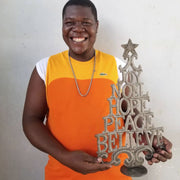 Jean Joseph Son is the artist who makes this Recycled Metal Christmas Tree Decor with Inspirational Words