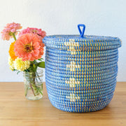 Blossom Lidded Storage Basket - Blue styled next to a bouquet of flowers