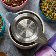Tea Infuser with Dual-use Coaster Lid in use on top of a tea cup