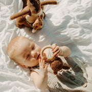 Baby holding a Kangaroo Wooden Teething Ring Rattle