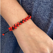 Red and Black Huayruro Seed Bracelet on model
